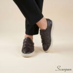 Visão superior no pé do tênis de couro com velcro ajustável marrom