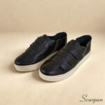 Visão superior lateral do par de tênis de couro com velcro ajustável Preto